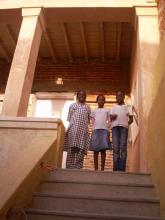 3 people stood at the top of a staircase