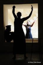 The silhouettes of two people in front of a third person