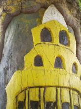 A carving of a building in wood