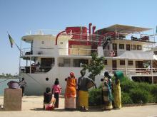 A group of people stood in front of a boat