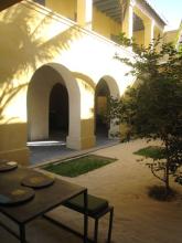 A courtyard with a tree and archways
