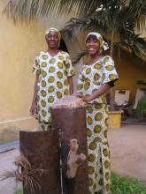 Two women stood behind some metal sculptures 