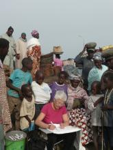A group of people watching a person write